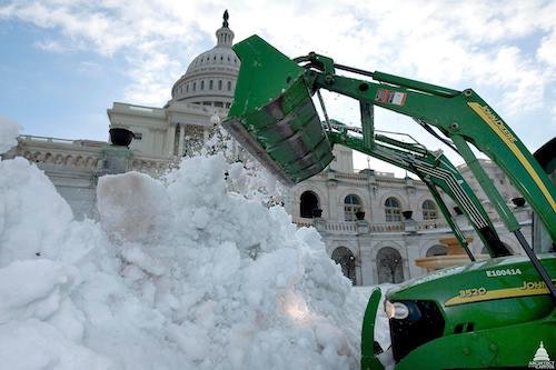 Snow removal operations taking place in front of the U.S. Capitol in Washington, D.C.
